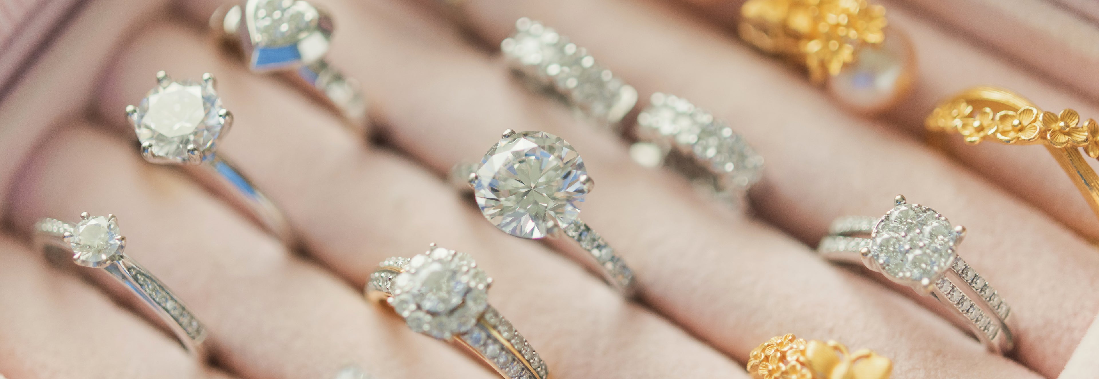 Close-up of various diamond rings on a hand
