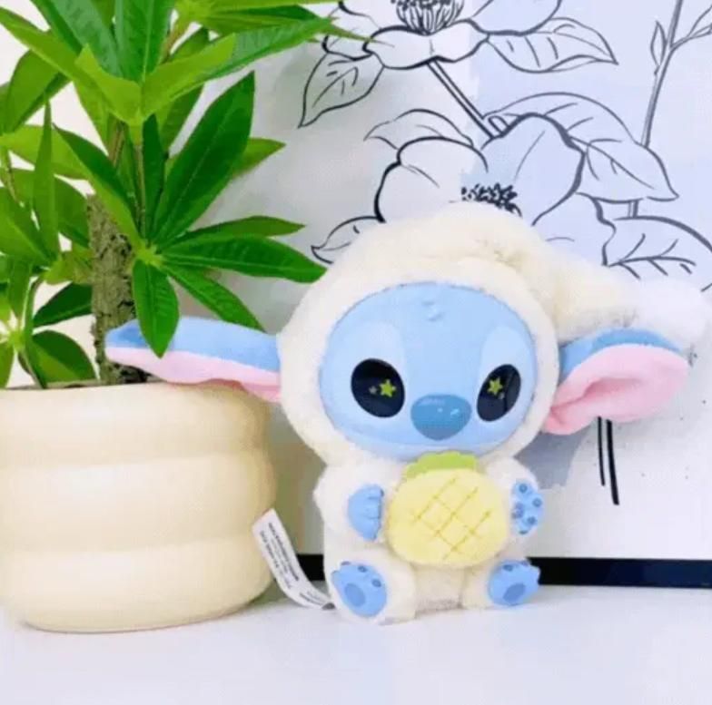 Plush toy resembling a character with a pineapple, next to a plant and floral design.