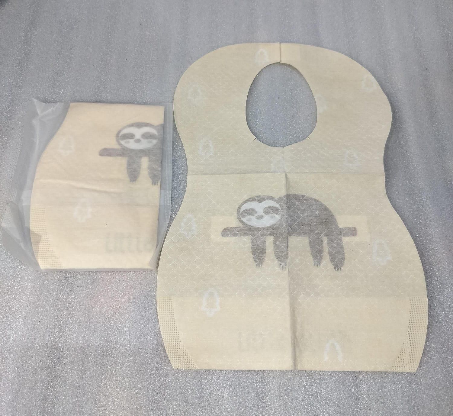 Beige bib with sloth design on a gray background
