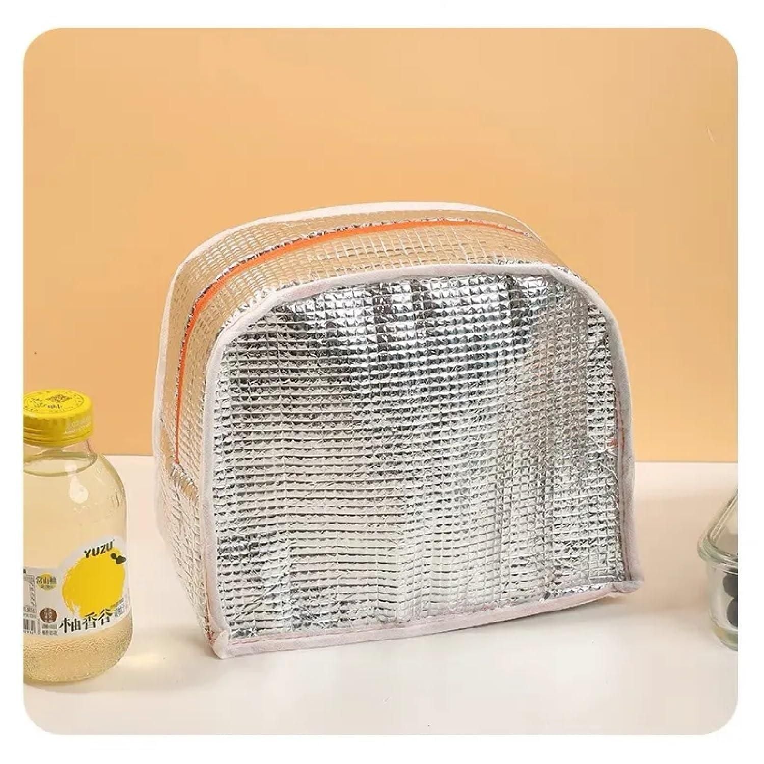 Silver insulated bag on a white surface with a beige background