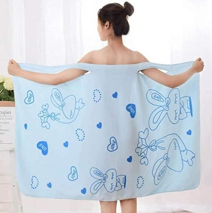 Person holding a blue towel with cartoon designs on a white background
