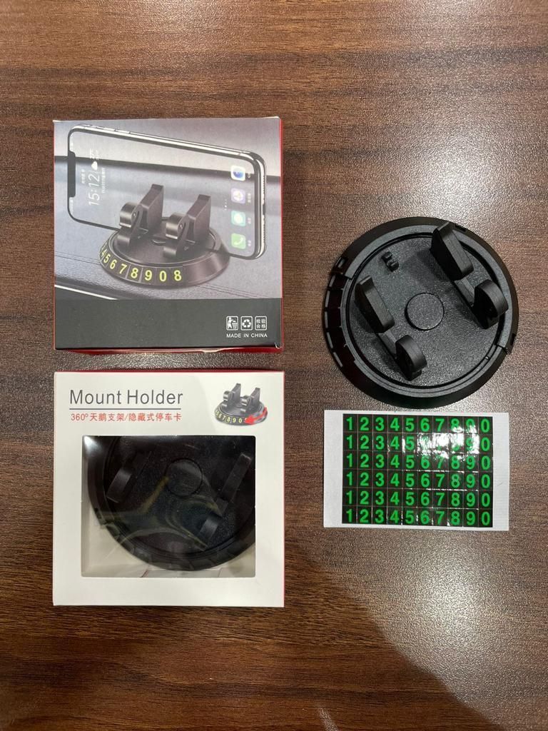 Mount holder with packaging and a sticker on a wooden surface