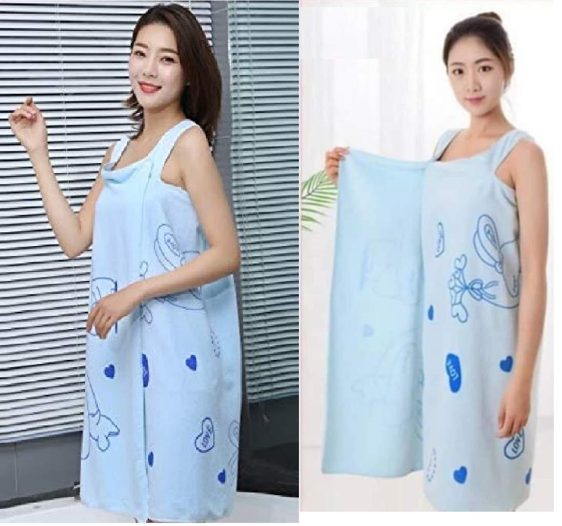 Woman holding a light blue apron with cartoon designs in two different poses.