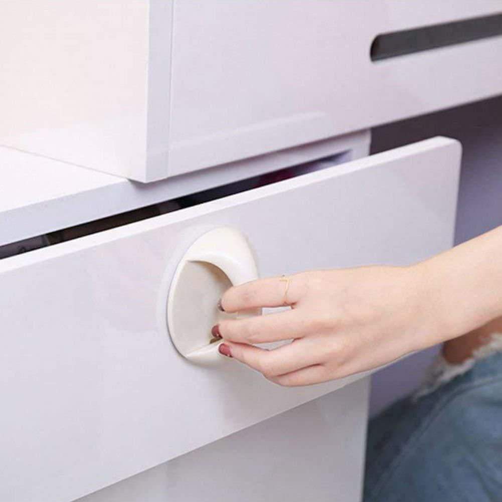 Child safety lock on a drawer with a hand attempting to open it.