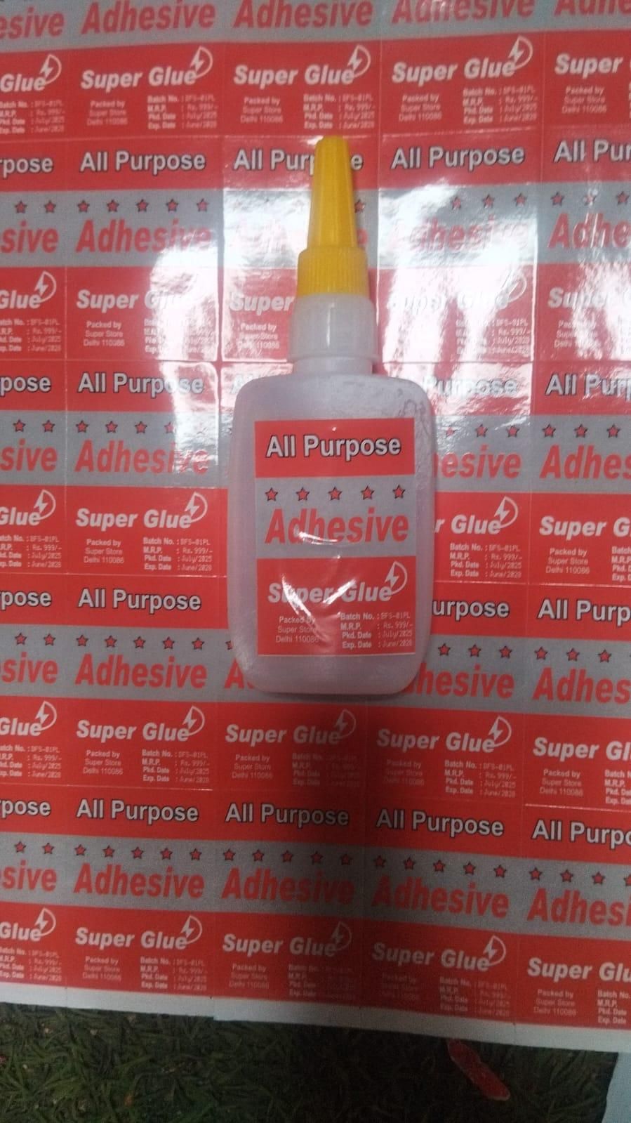 Super Glue bottle with red label on a white background