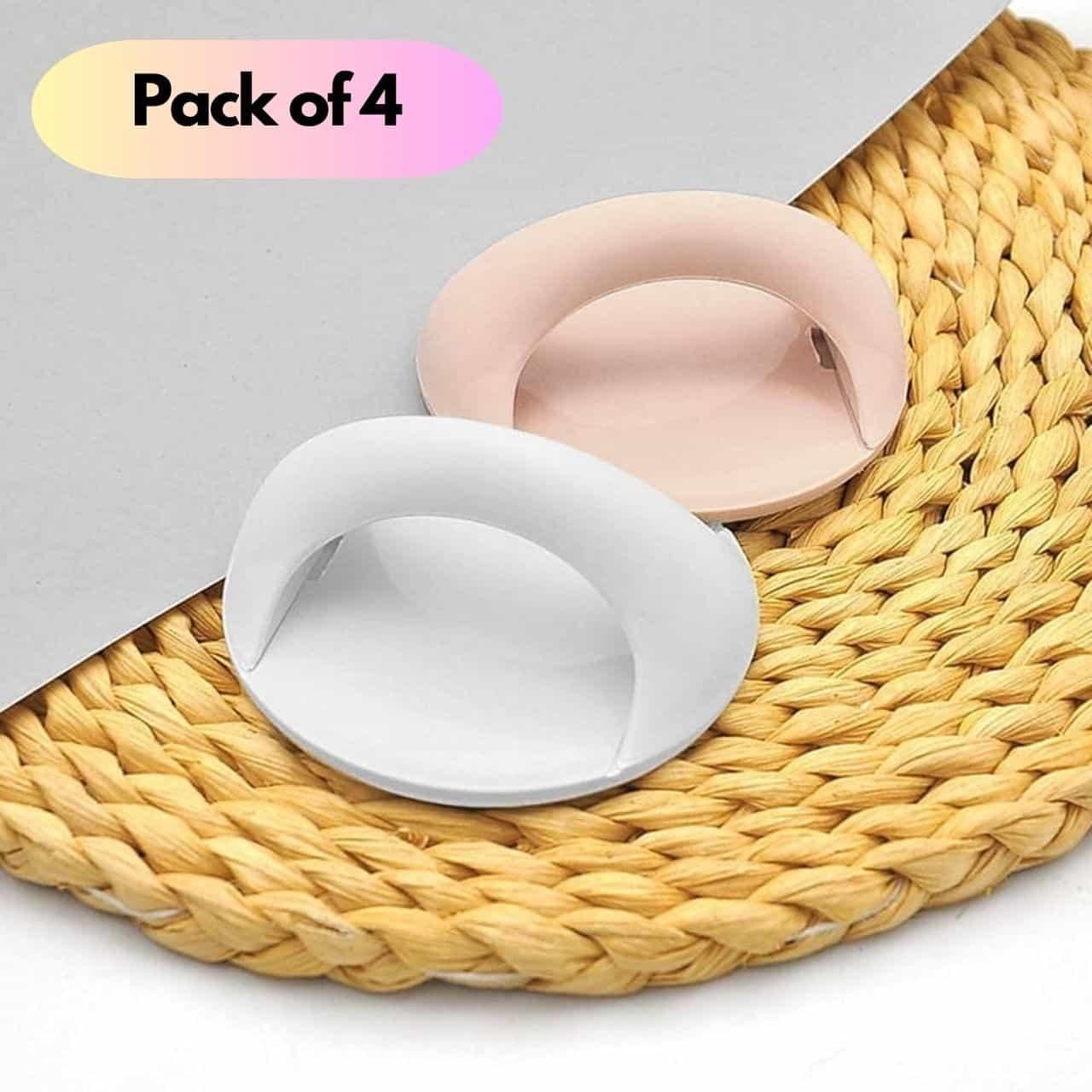 Two silicone coasters, one white and one pink, on a woven mat with 'Pack of 4' text above.