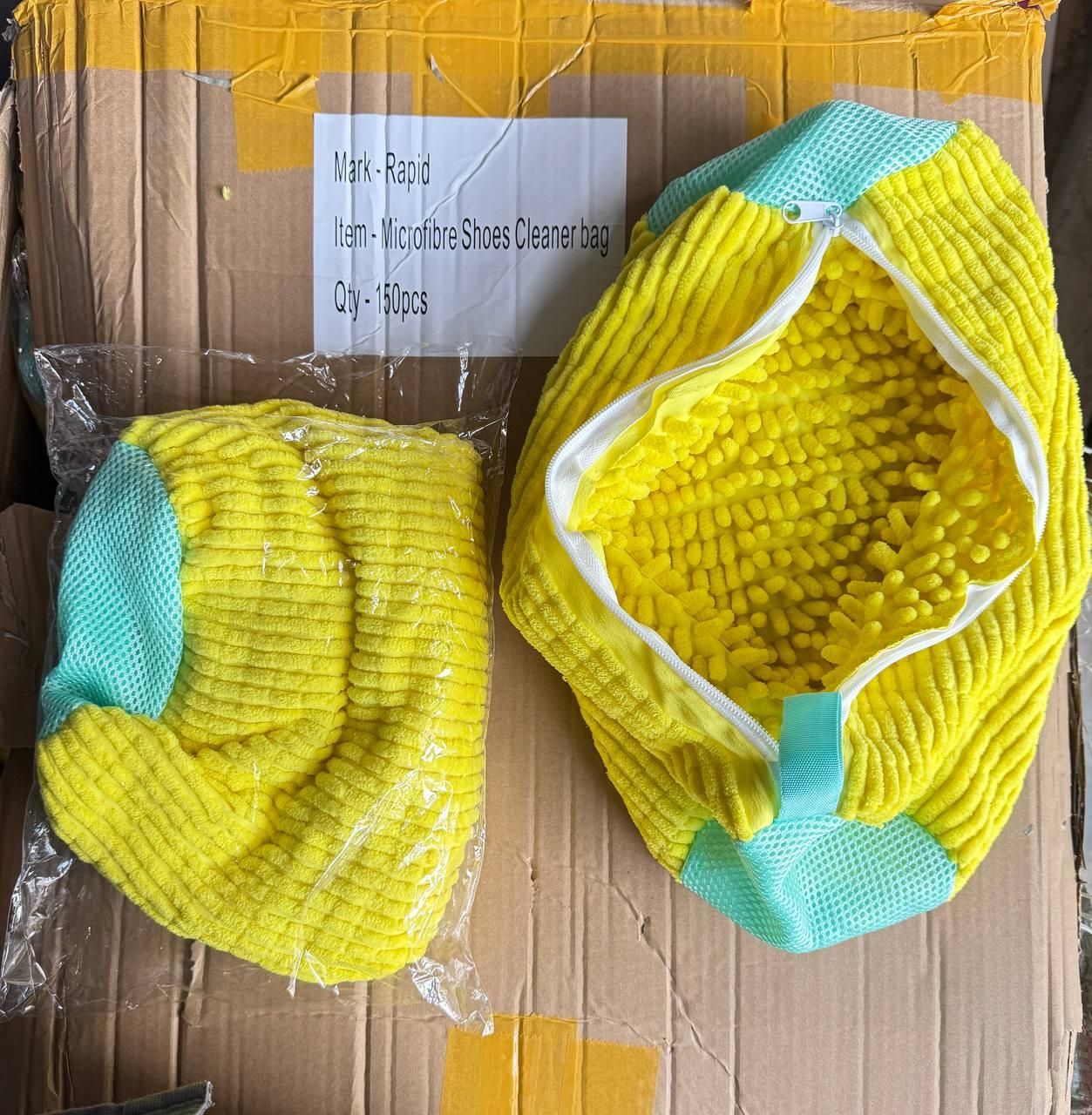 Yellow microfiber shoes cleaner bags on a cardboard box with labels.