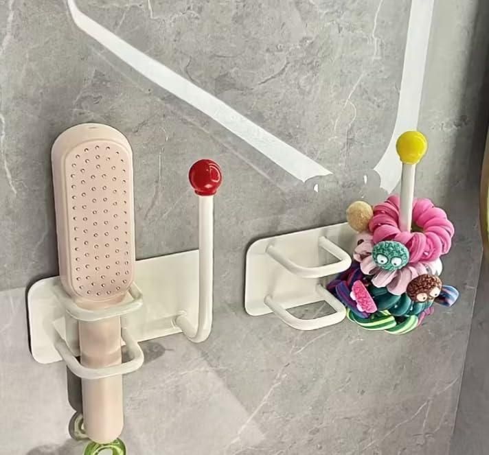 Bathroom organizer with various items including a brush and hair ties on a gray tiled wall.
