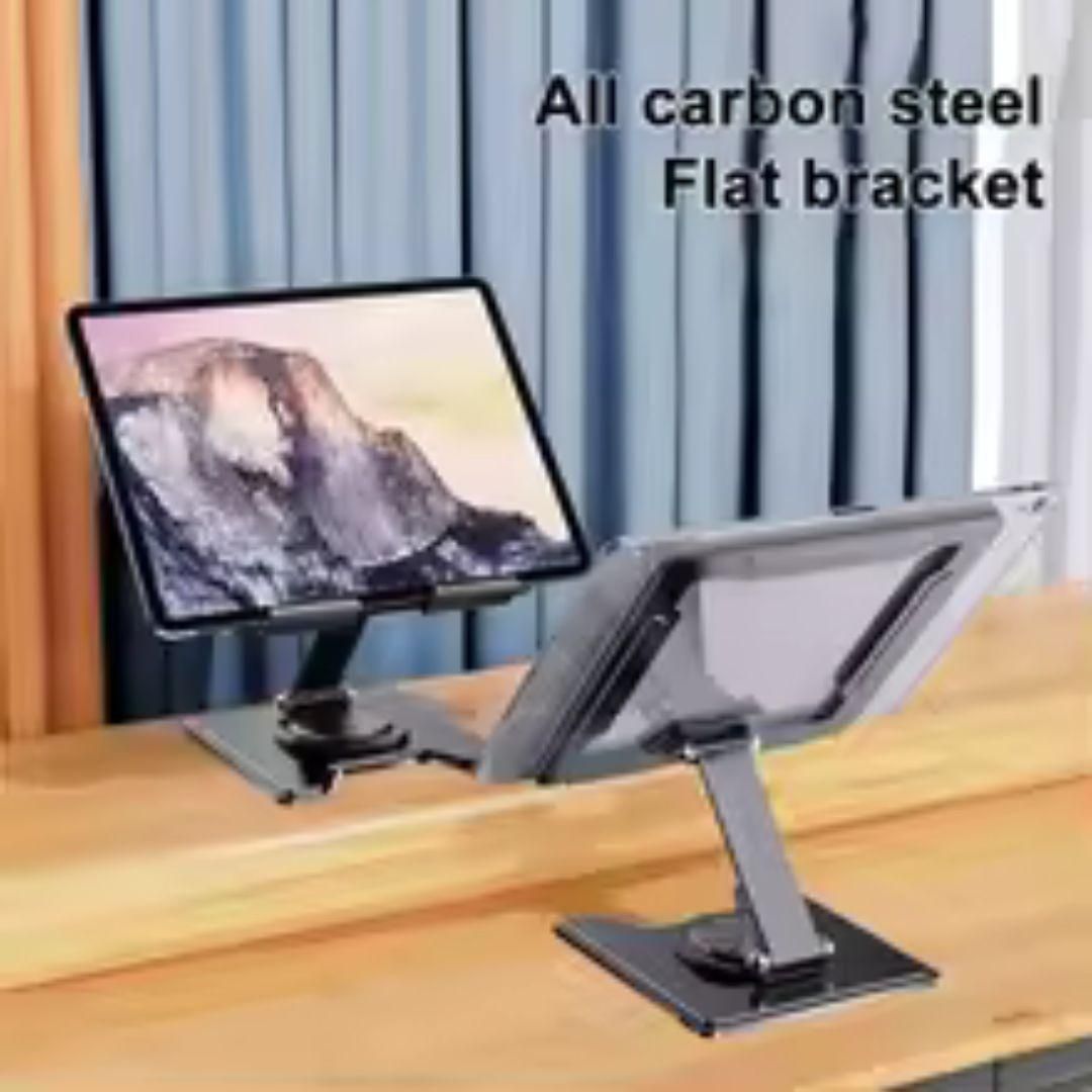 Carbon steel flat bracket holding a tablet on a wooden surface with curtains in the background.