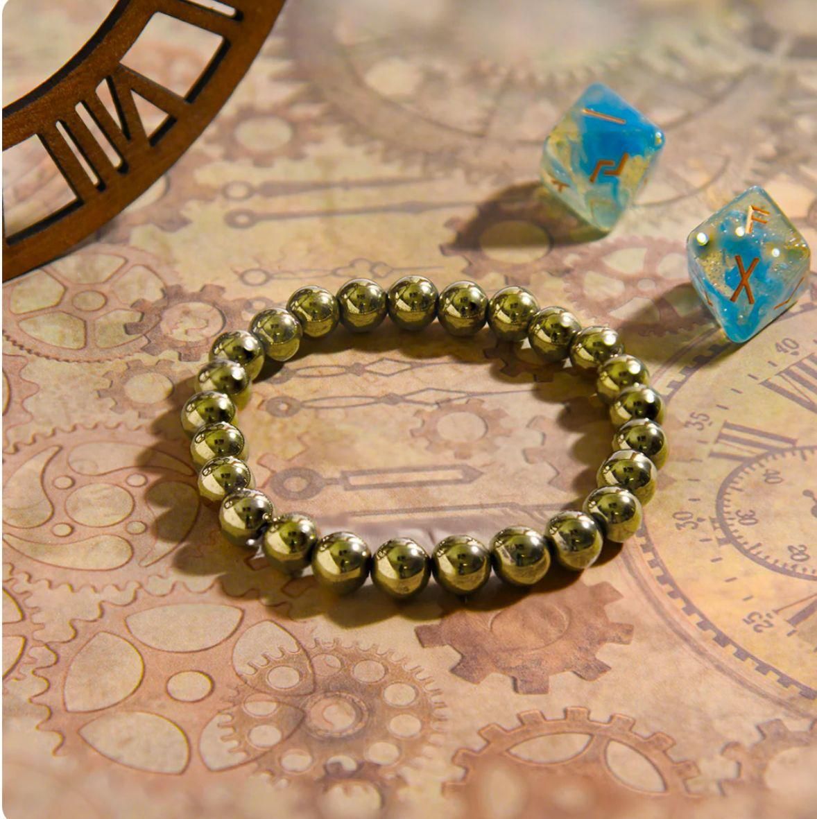 Gold beaded bracelet on an old map with dice