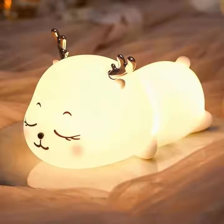 Cute animal-shaped night light on a wooden surface