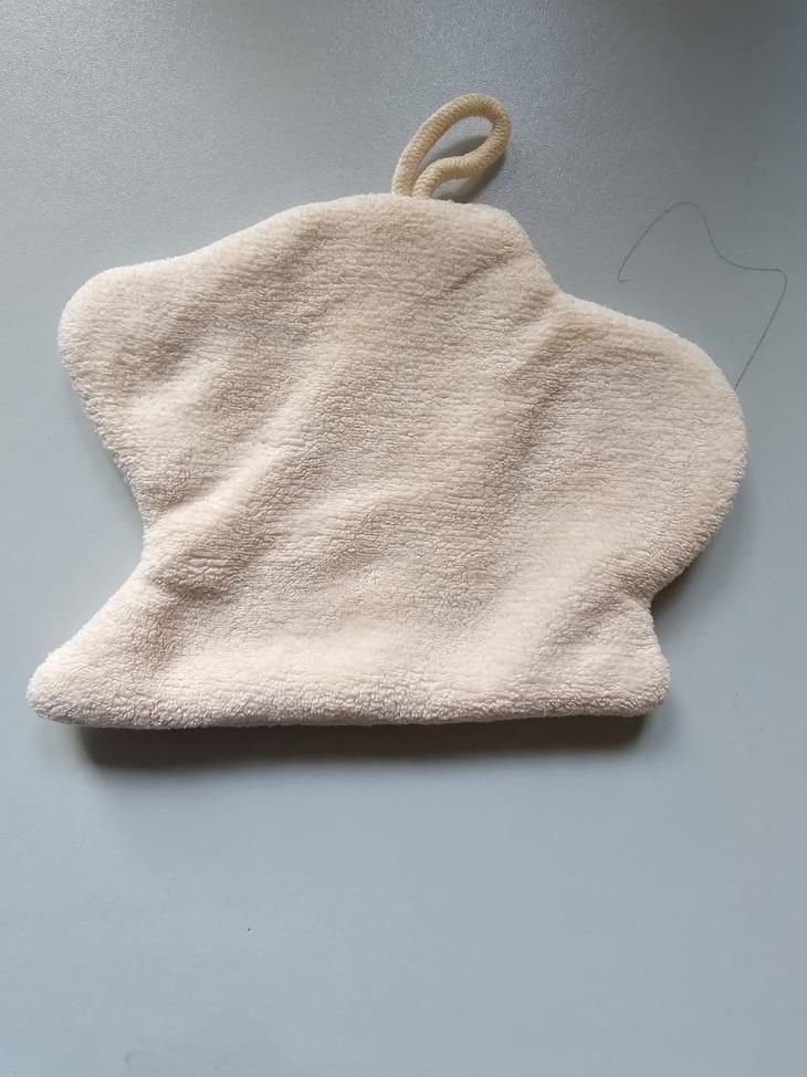 Beige bath mitt on a gray background