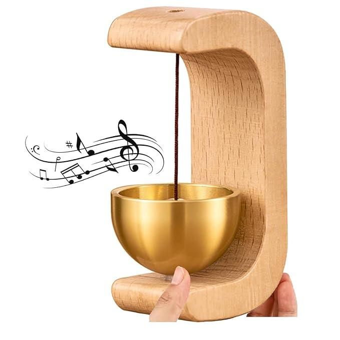 Wooden and gold metal instrument held by a hand with musical notes above