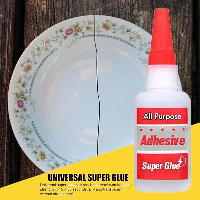 Super glue bottle with a cracked plate on a wooden background